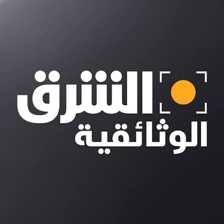 Arabic text logo with white typography and yellow circle on dark background, appears to be a media or news organization branding
